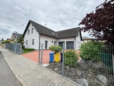 a white house with a fence in front of it at U tří koček in Herink