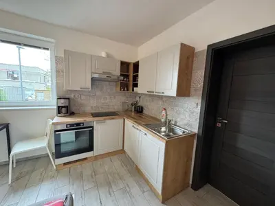 a kitchen with white cabinets and a sink at U tří koček in Herink