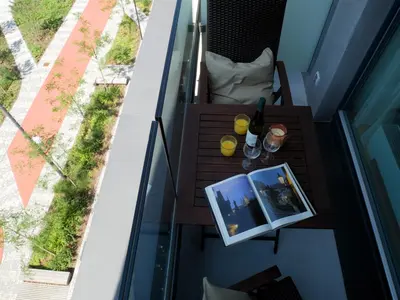 an apartment balcony with a table with two pictures on it at Charming apartment with a balcony in a great location in Prague