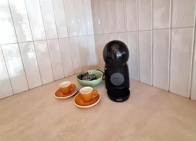 a coffee maker and two cups on a counter at Charming apartment with a balcony in a great location in Prague