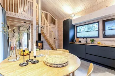 a dining room with a wooden table in a kitchen at Finskä chata in Samopše