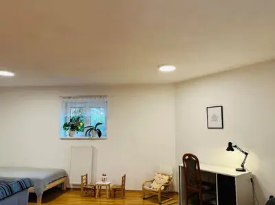 a bedroom with a bed and a table and chairs at Family-Friendly Prague 5 Stay in Prague
