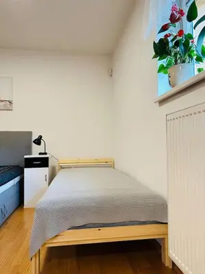 a bedroom with a bed with a plant on the wall at Family-Friendly Prague 5 Stay in Prague