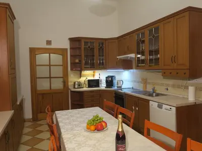 a kitchen with a table with a bottle of wine at Apartments near Lesser Town in Prague