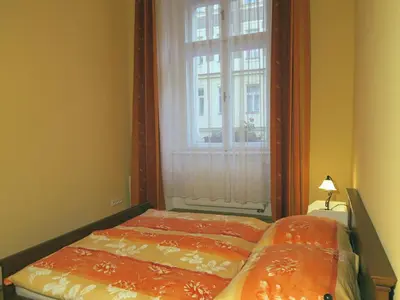 a bedroom with a bed and a window with at Apartments near Lesser Town in Prague