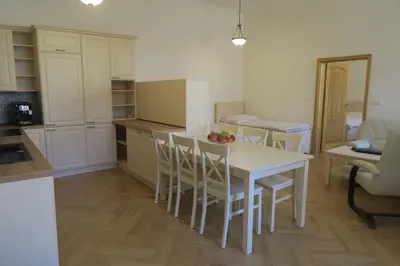 a kitchen with a table and chairs in a room at Apartments near Lesser Town in Prague