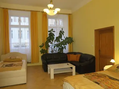 a living room with a couch and a chair and a table at Apartments near Lesser Town in Prague