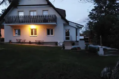 a white house with a balcony on top of a yard at Klasický dům, 5 ložnic , 5 bedrooms, Praha in Prague