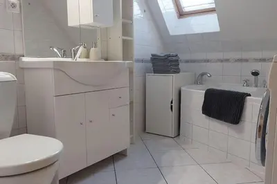 a white bathroom with a sink and a toilet at Klasický dům, 5 ložnic , 5 bedrooms, Praha in Prague