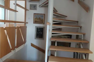 a staircase in a room with wooden shelves at Klasický dům, 5 ložnic , 5 bedrooms, Praha in Prague