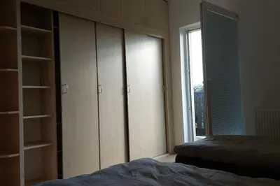 a bedroom with a bed and a closet and a window at Klasický dům, 5 ložnic , 5 bedrooms, Praha in Prague