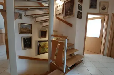 a staircase in a room with paintings on the wall at Klasický dům, 5 ložnic , 5 bedrooms, Praha in Prague