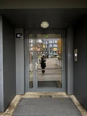 a person walking through the door of a building at Garden Towers Apartment in Prague Center in Prague