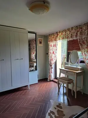 a bathroom with a vanity and a mirror on a table at Лесной Коттедж Нова in Živohošť