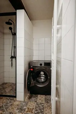 a bathroom with a black toilet in a room at Vítovský statek in Žižice