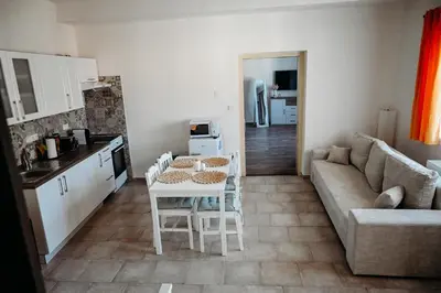 a kitchen and living room with a table and a couch at Vítovský statek in Žižice
