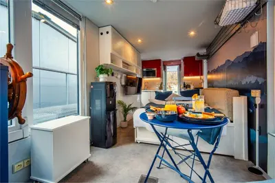 a kitchen with a table with food on it at Houseboat Prague with Paddle Boat -Sail, Explore and Relax in Prague