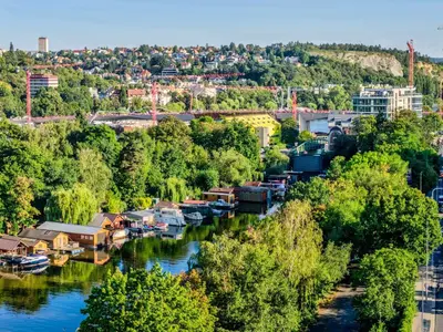 an aerial view of a river with boats docked at Houseboat Prague with Paddle Boat -Sail, Explore and Relax in Prague