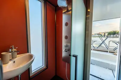 a bathroom with a sink and a window at Houseboat Prague with Paddle Boat -Sail, Explore and Relax in Prague