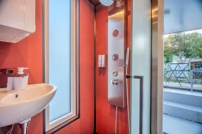 a bathroom with a sink and a window at Houseboat Prague with Paddle Boat -Sail, Explore and Relax in Prague