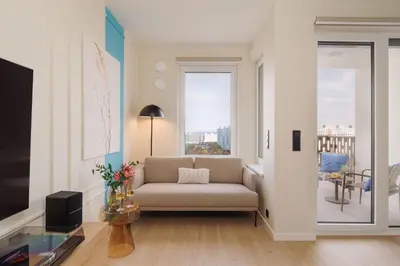 a living room with a couch and a window at Good Vibe Studio near Metro - Garage, Air-Conditioning, Vinyl player in Prague