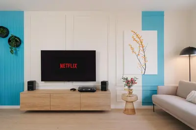 a living room with a television on a wooden entertainment center at Good Vibe Studio near Metro - Garage, Air-Conditioning, Vinyl player in Prague