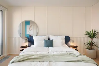 a bedroom with a large bed and a mirror at Good Vibe Studio near Metro - Garage, Air-Conditioning, Vinyl player in Prague