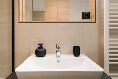 a white sink in a bathroom with a mirror at Good Vibe Studio near Metro - Garage, Air-Conditioning, Vinyl player in Prague