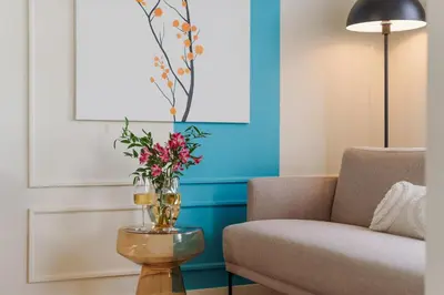 a living room with a couch and a vase of flowers at Good Vibe Studio near Metro - Garage, Air-Conditioning, Vinyl player in Prague