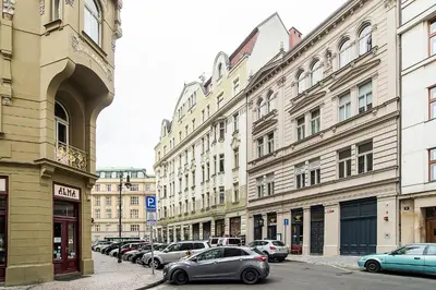 a row of buildings with cars parked on a street at Large and modern apartment in the heart of Prague in Prague