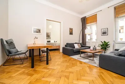 a living room with a couch and a table at Large and modern apartment in the heart of Prague in Prague