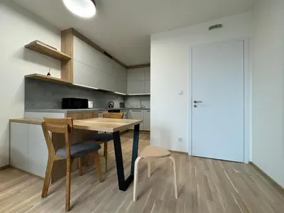 a kitchen with a table and chairs in a room at Smíchov City apartment - Albrigtova in Prague