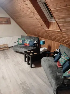 a living room with a couch and a bar in a room at Apartmán Roztoky u Křivoklátu in Roztoky