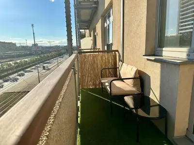 a balcony with a chair on a building at Apartment Českomoravská - O2 Arena Prague in Prague