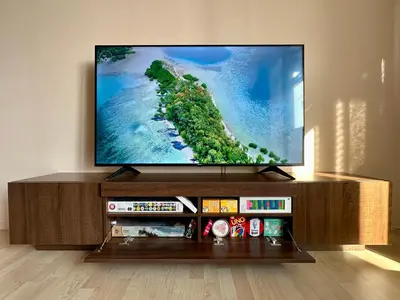 a flat screen tv sitting on top of a entertainment center at Apartment Českomoravská - O2 Arena Prague in Prague