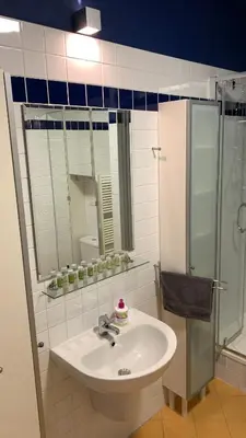 a bathroom with a sink and a shower at Apartment Českomoravská - O2 Arena Prague in Prague