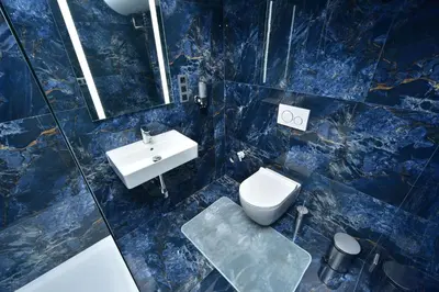 a blue bathroom with a sink and a toilet at TF Wellness in Prague