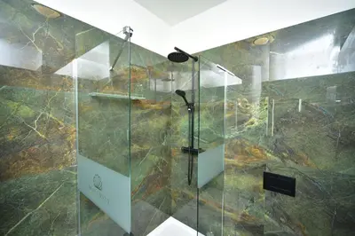 a shower with a glass door in a bathroom at TF Wellness in Prague