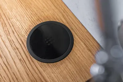 a black object sitting on top of a wooden table at Manažerské bydlení - ROHAN CITY in Prague