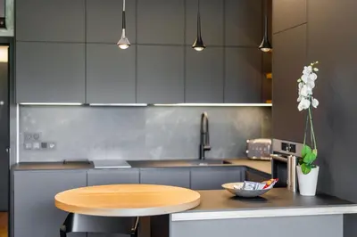 a kitchen with a wooden table and a counter top at Manažerské bydlení - ROHAN CITY in Prague