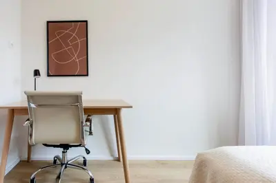 a desk with a chair next to a bed at Blueground Holešovice family-friendly nr park PRG-3 in Prague