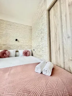 a bedroom with a large bed with two pillows on it at Apartment in the center on Sokolska street in Prague