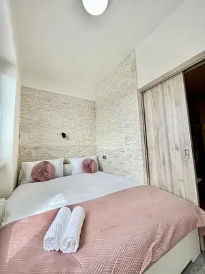 a bedroom with a large bed with two white socks on it at Apartment in the center on Sokolska street in Prague