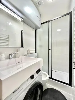 a bathroom with a white sink and a toilet at Apartment in the center on Sokolska street in Prague