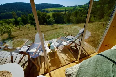 a group of chairs sitting in a room with a window at Ztracený Sad - Glamping na samotě in Nečín