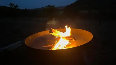 a fire pit in the middle of a yard at Ztracený Sad - Glamping na samotě in Nečín