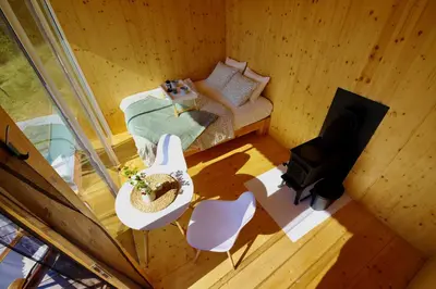 an overhead view of a room with a bed and a television at Ztracený Sad - Glamping na samotě in Nečín