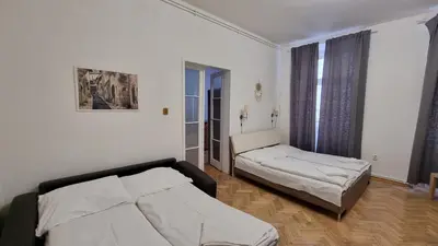 a bedroom with two beds and a window at Apartment Krakovska 20 in Prague