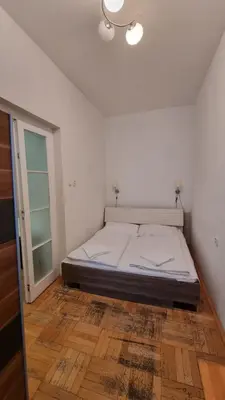 a bedroom with a bed in a white room at Apartment Krakovska 20 in Prague