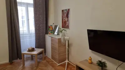 a living room with a flat screen tv on a wall at Apartment Krakovska 20 in Prague